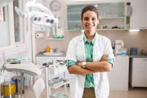 Women Dentist Standing in the Clinic