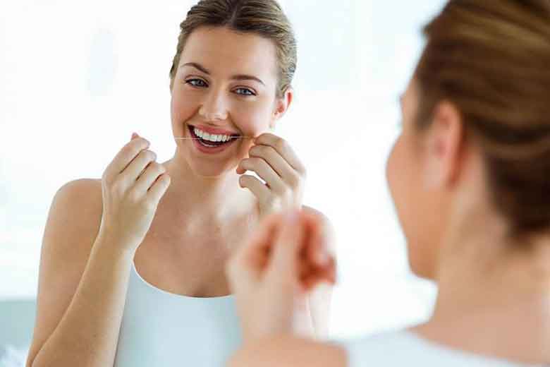 A women cleaning Teeth