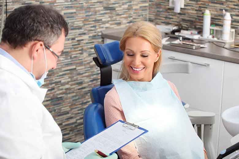 Women sitting on the chair and dentist explaining the women