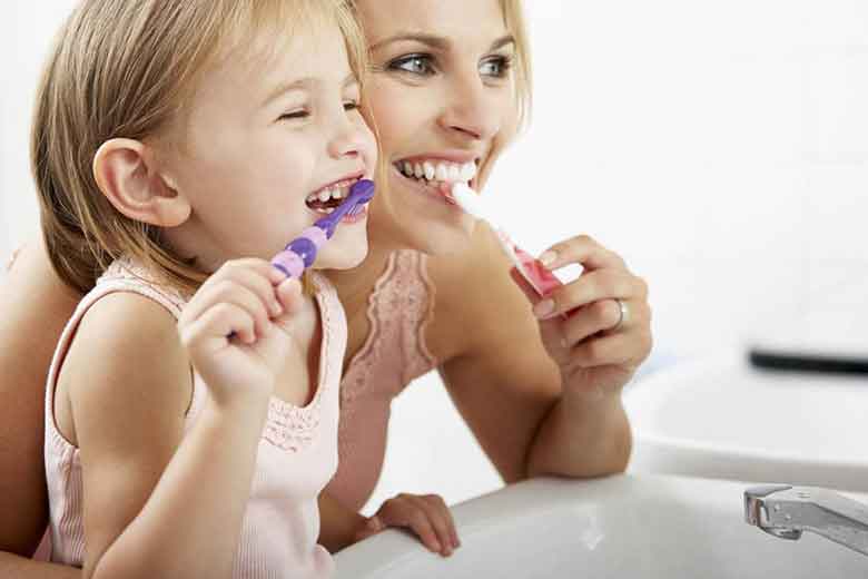 Mother and Daughter Brushing the teeth
