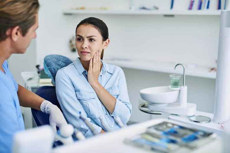 Women Explaining tooth ache issue to the dentist