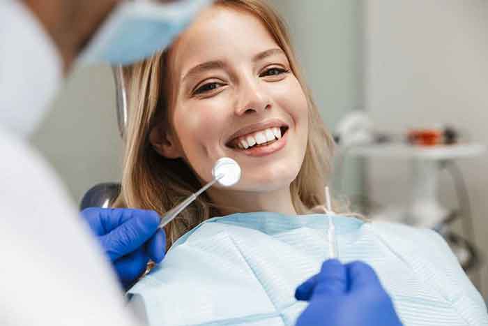 Smiling Girl is treated by the dentist