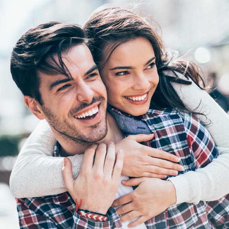 smiling and hugging young couple