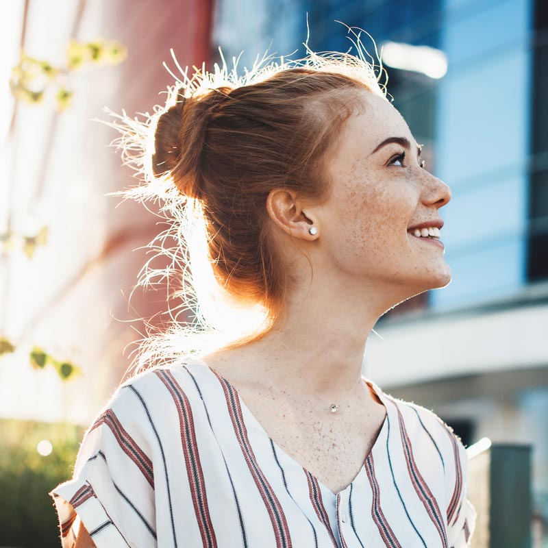 A Woman Emphasizing Her Beautiful Smile From Parker Dental Veneers in Parker, CO
