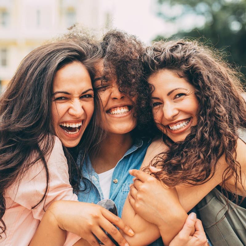 three friends smiling and laughing