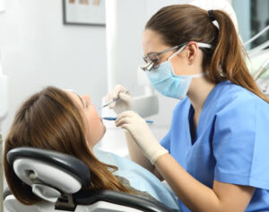 an oral hygienist completing a dental cleaning on a patient in Parker, CO