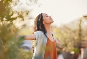 A woman with good oral health enjoying nature in Parker, CO