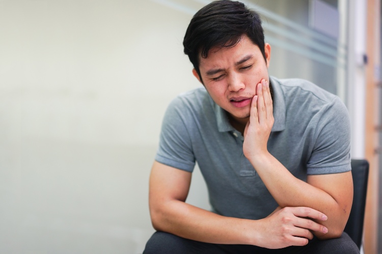 Man in Pain with TMJ Disorders