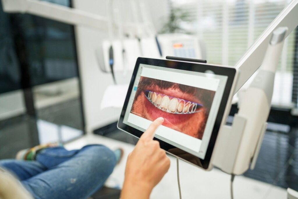 Patient Pointing on screen at Dental Appointment